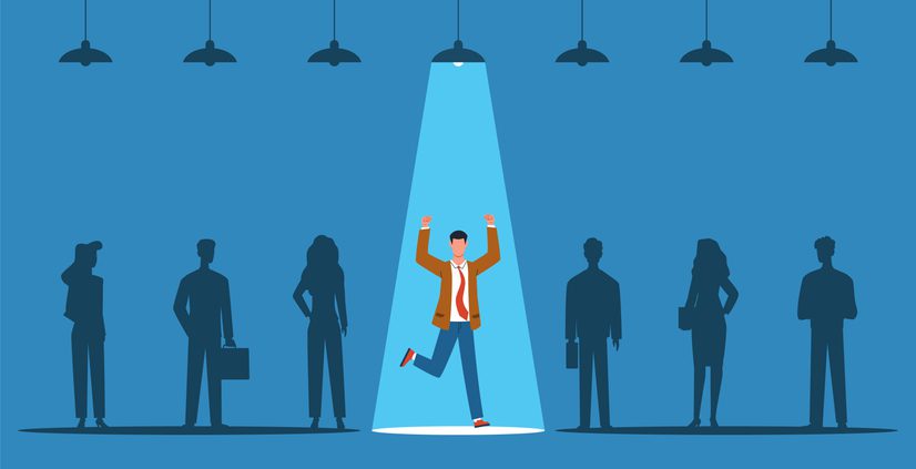 Silhouetted group of six people standing in a row against a blue background. One person in the center is spotlighted with raised arms and lifted leg, appearing celebratory. Only the light above this person is turned on; others remain in shadow.